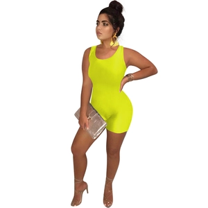 Sleeveless slim fit neon yellow romper shown with silver clutch and strappy sandals