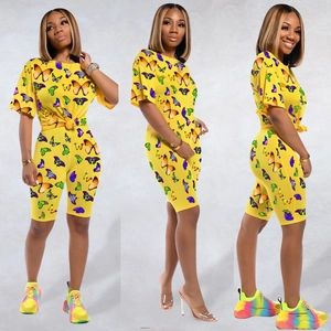 Women's yellow butterfly print two-piece activewear set with cropped tie-front t-shirt