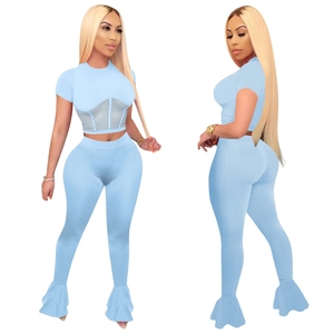 Detail of light blue mesh patchwork crop top and matching flared pants outfit set