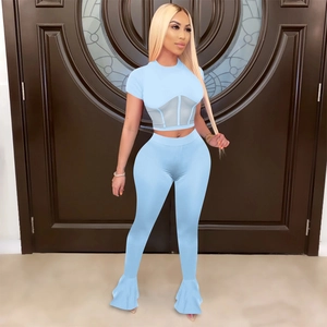 Detail view of sky blue two-piece set featuring mesh waist panels and flared pants
