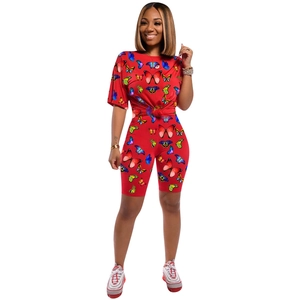 Detailed view of red butterfly print short sleeve top and matching biker shorts set
