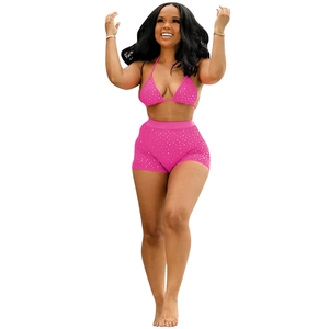 Detail view of sparkly hot pink two-piece set with sequins and high-waisted shorts