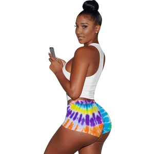 Detail of high-waisted tie-dye bodycon shorts and white sleeveless crop top set