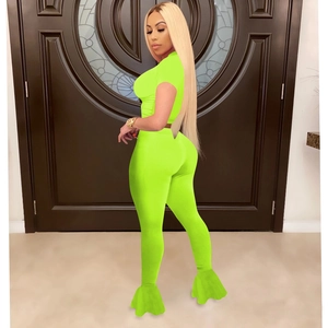 Detail of neon green two-piece set with mesh patchwork flare pants and crop top