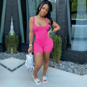 Detailed close-up of hot pink sleeveless bodysuit with U-neckline and bodycon fit design