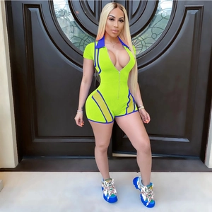Detail of neon green V-neck romper with blue mesh inserts and metal zipper closure