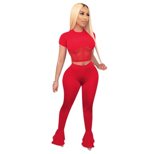 Detail of red two-piece set featuring mesh splice crop top and high waist flare pants