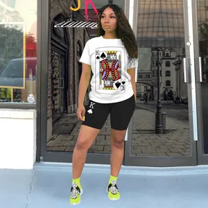 Close-up of playing card King of Spades print on white T-shirt and black shorts set