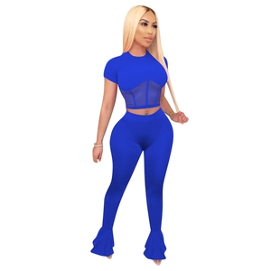 Detail of blue two-piece set featuring sheer mesh patchwork and ruffled flare pants