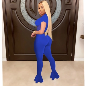 Side-rear view of blue two-piece sports set featuring mesh flared pants and crop top