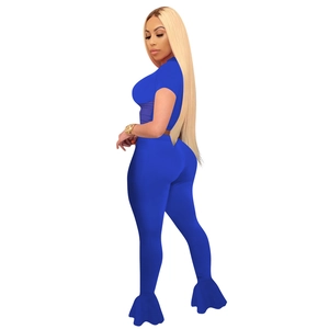 Side view of royal blue two-piece set featuring flared mesh hem pants and crop top