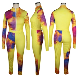 Detail view of yellow tie-dye tracksuit set with front zipper and thumbhole sleeves