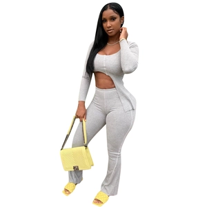 Women's grey ribbed knit two-piece set featuring cutout top and flared pants