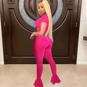Vibrant rose red two-piece set featuring mesh crop top and high-waist flared pants
