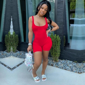 Detail showing the red slim fit sleeveless romper with a deep U-neckline design