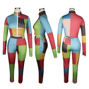 Detail view of colorful patchwork two-piece set featuring mock neck and long sleeves