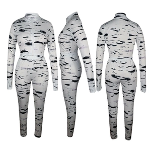 Three-way view of two-piece set showing black stripe print on white fabric texture