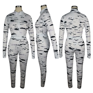 Three-view detail of women's two-piece tracksuit with abstract zebra print and zipper neck