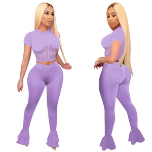Detail of purple two-piece sports set with mesh patchwork and flared leggings