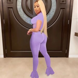 Close-up of purple two-piece set featuring mesh paneling and flared bell-bottom pants