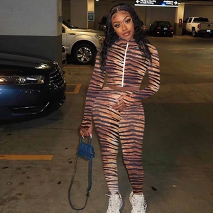 Detailed view of women's two-piece tracksuit with brown tiger print and front zipper