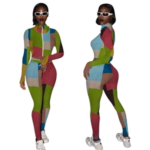 Detail of a two-piece slim fit tracksuit with colorful patchwork and standing collar zipper