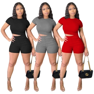 Women's two-piece ribbed knit lounge set featuring crop top and ruched shorts in three colors