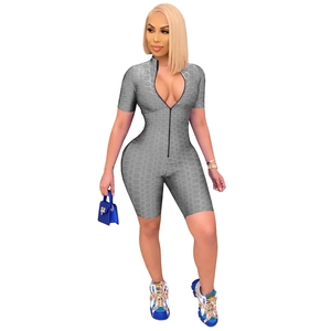 Close-up of gray zippered romper showing textured waffle honeycomb knit fabric detail