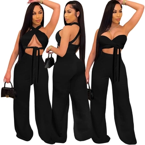 Women's black two-piece set featuring a halter crop top and high waist wide leg pants