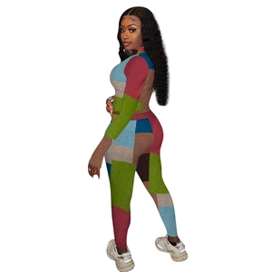 Detail view of multicolored geometric panel stitching on a long-sleeve slim fit jumpsuit