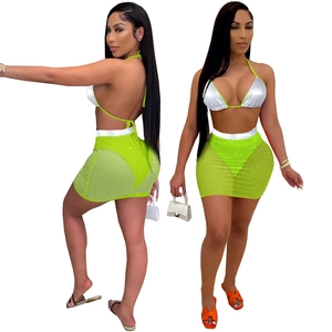 Two-piece bikini set with silver halter top and neon green rhinestone mesh skirt