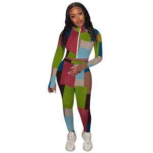 Detail view of colorful geometric patchwork slim fit bodysuit with front zipper closure