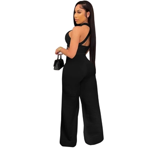 Detail showing the elegant backless halter neck design with crisscross straps and high waist