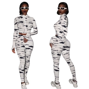 Detail of two-piece sports set with abstract black patterns and high-waist yoga pants