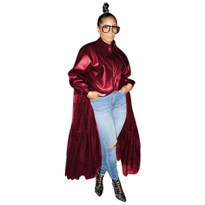 Detail view of burgundy PU leather coat featuring a layered ruffle hem and metallic finish