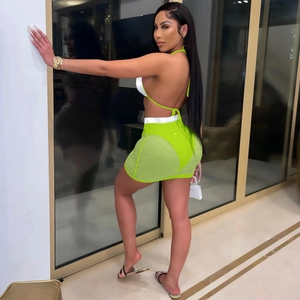 Detail of neon green mesh skirt with silver waistband and sparkling rhinestone accents