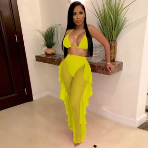 Bright yellow mesh two-piece set featuring halter top and tiered ruffle sheer pants
