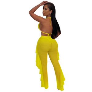 Detail of yellow mesh two-piece set featuring halter top and ruffled sheer pants