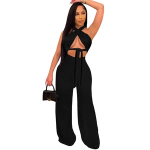Detail of black halter cross top and high-waist wide-leg pants set for women