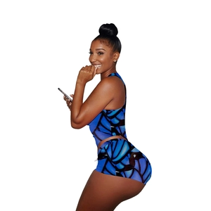 Side view of electric blue butterfly wing print athletic crop top and shorts set