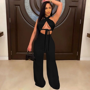 Detailed view of black two-piece set featuring halter crisscross top and wide-leg trousers