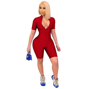 Detail of red athletic romper featuring honeycomb 3D texture and front zipper closure