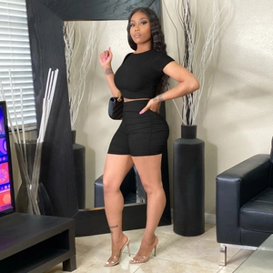 Women's black two-piece ribbed knit short sleeve crop top and bodycon shorts set