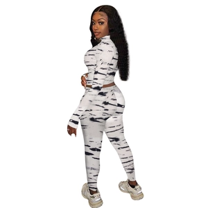 Detail of white marble print knit sportswear set featuring high waist leggings and top