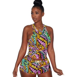 Detail of vibrant butterfly print on women's athletic tank top and drawstring shorts