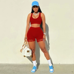 Deep red women's two-piece sports set with lace-up shorts and racerback crop top