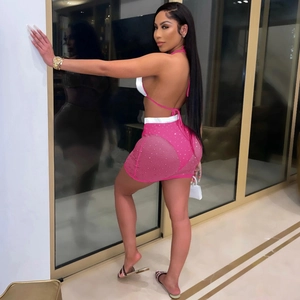 Detailed back view of a pink mesh sequin skirt set with halter top and sheer mini skirt