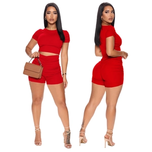 Front and back view of red ribbed knit crop top and ruched high-waist shorts set