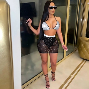 Detail of silver halter bikini top and black mesh sequin skirt three-piece swimwear set