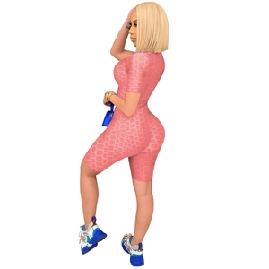 Detail of pink honeycomb textured women's yoga jumpsuit showing compression fabric